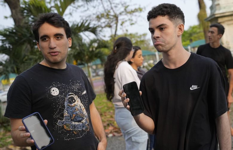 University students show their phone screens after social media platform X was blocked nationwide, in Rio de Janeiro, Monday, Sept. 2, 2024. (AP Photo/Silvia Izquierdo) 