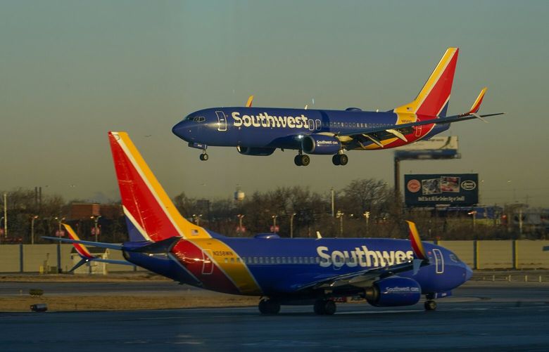 FILE – A Southwest Airlines plane prepares to land at Midway International Airport while another taxis on the ground, Feb. 12, 2023, in Chicago. (AP Photo/Kiichiro Sato, File) NYRL220 NYRL220