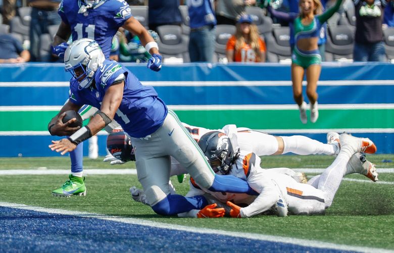 Geno Smith gets to the goal line to score on a 34-yard run in the second quarter.  The Denver Broncos played the Seattle Seahawks in NFL Football Sunday, September 8, 2024 at Lumen Field, in Seattle, WA. 227925
