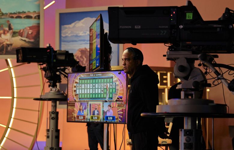A crew member watches the filming of an episode of Wheel of Fortune at Sony Picture Studios in Culver City, Calif., on July 26, 2024. But a lot is changing this season for “Wheel of Fortune,” one of the longest-running game shows on television. The biggest change: Ryan Seacrest takes over as host, beginning Sept. 9, replacing Pat Sajak and his more than four-decade run on the show. (Philip Cheung/The New York Times) XNYT0031 XNYT0031