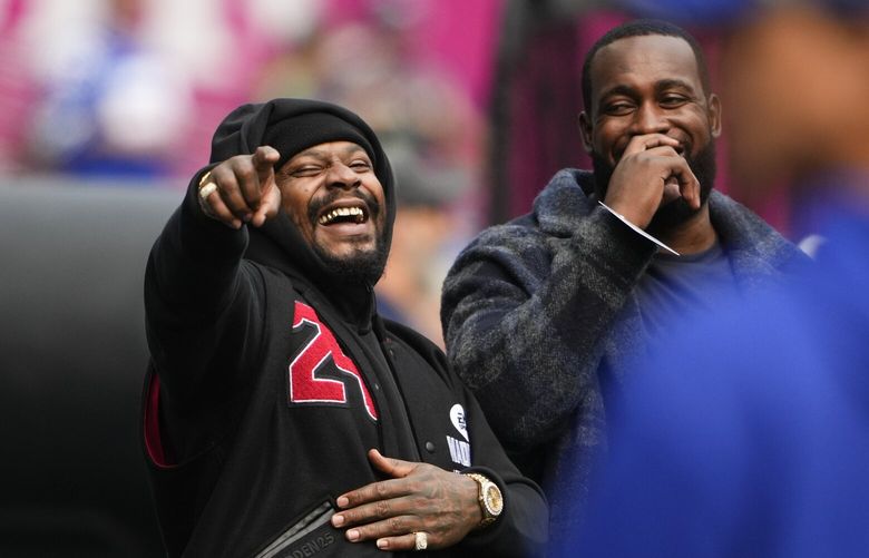 Former Seattle Seahawks’ Kam Chancellor, right, laughs while talking with former NFL player Marshawn Lynch before an NFL football game between the Seattle Seahawks and the Denver Broncos, Sunday, Sept. 8, 2024, in Seattle. (AP Photo/Lindsey Wasson) WAJK1 WAJK1