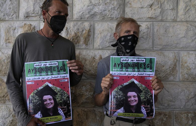 ADDS WITNESS SAYS: Two fellow activists of Aysenur Ezgi Eygi, 26, who a witness says was fatally shot by Israeli soldiers while participating in an anti-settlement protest in the West Bank, carry posters with her name and photo during Eygi’s funeral procession in the West Bank city of Nablus, Monday, Sept. 9, 2024. (AP Photo/Nasser Nasser) NN101 NN101