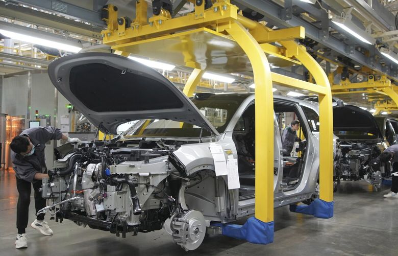 FILE – A worker assembles an SUV at a car plant of Li Auto, a major Chinese EV maker, in Changzhou in eastern China’s Jiangsu province, March 27, 2024. (Chinatopix Via AP, File) XHG514 XHG514