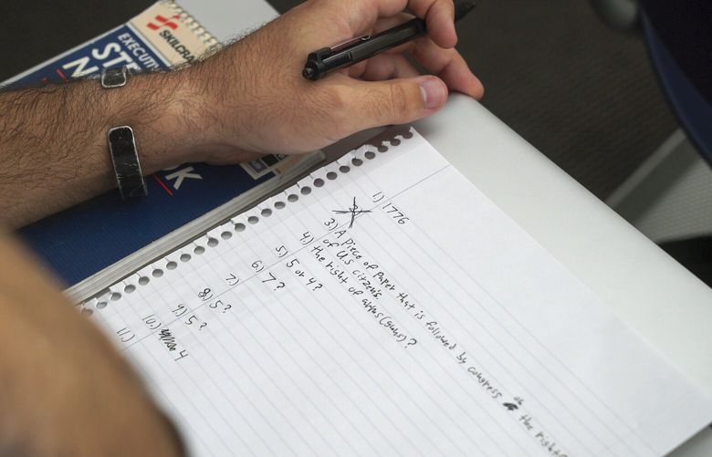 A student checks a classmate’s test during an American government class at the University of South Carolina Beaufort in Bluffton, S.C., on Tuesday, Aug. 20, 2024. (AP Photo/Allen G. Breed) NY553 NY553