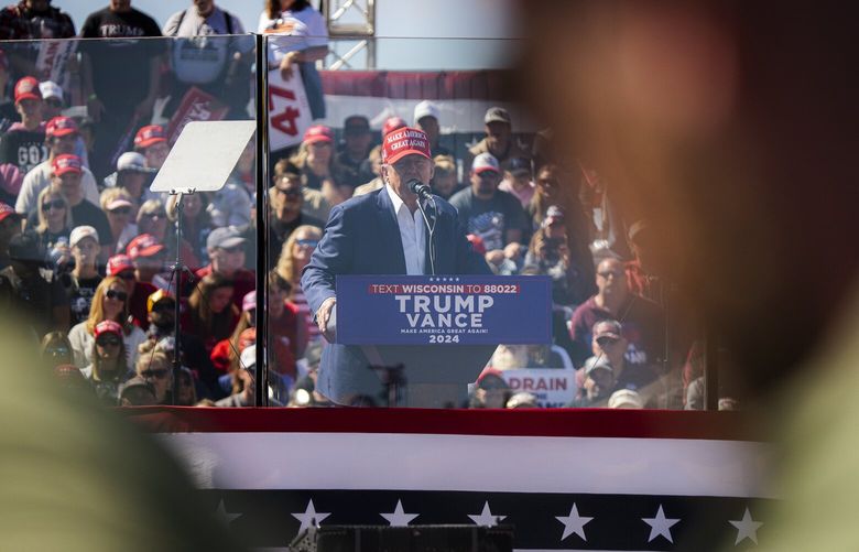 Former president Donald Trump delivers a speech from behind bulletproof glass at a rally at the Central Wisconsin Airport on Sept. 7. MUST CREDIT: Sara Stathas for The Washington Post