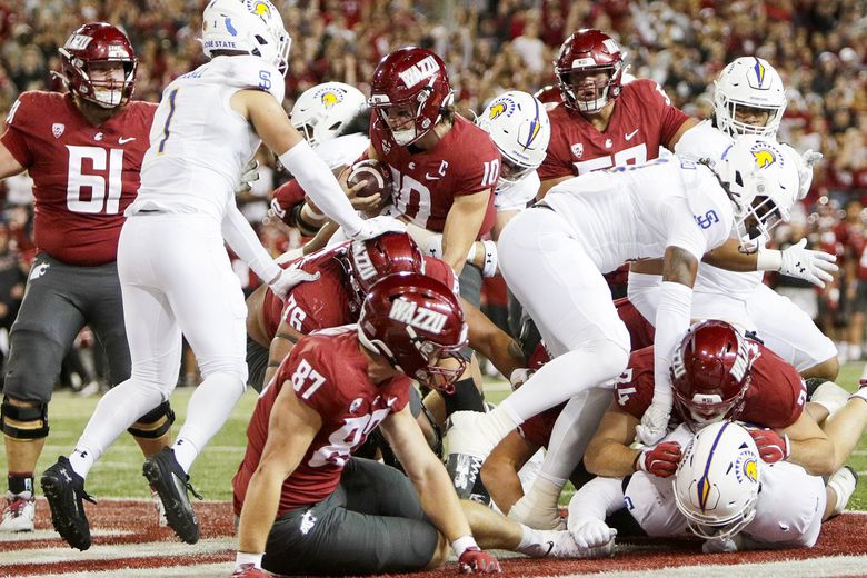 Washington State quarterback John Mateer (10), center, carries the ball for a touchdown during the first half of an NCAA college football game against San Jose State, Friday, Sept. 20, 2024, in Pullman, Wash. (Young Kwak / AP)