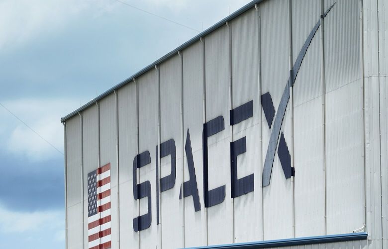 FILE – The SpaceX logo is displayed on a building, Tuesday, May 26, 2020, at the Kennedy Space Center in Cape Canaveral, Fla. (AP Photo/David J. Phillip, File) nydd201 nydd201