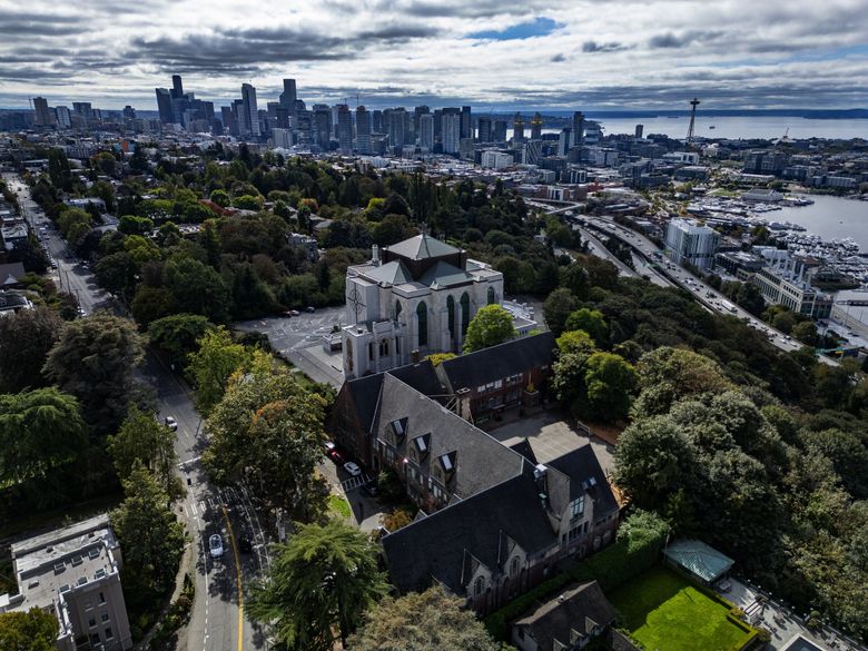 Perched northeast of downtown Seattle, Saint Mark’s Episcopal Cathedral sits next to its Saint Nicholas property (foreground), which it acquired in 2003. The building was home to a private girls’ school from 1926 to 1971. (Ken Lambert / The Seattle Times)