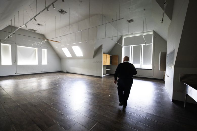 The Rev. Steven Thomason, of Saint Mark’s Episcopal Cathedral, walks through what had been an art classroom in the vast space of the cathedral campus’ Saint Nicholas building. The Capitol Hill congregation wants a partner to help usher in affordable housing here, but so far, Saint Mark’s hasn’t been able to find a developer to take on the project. (Ken Lambert / The Seattle Times)