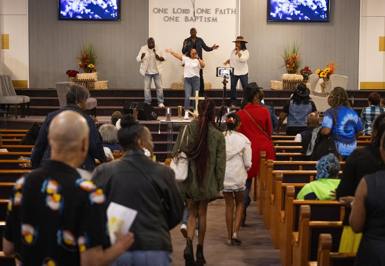 Members of the congregation arrive at Goodwill Missionary Baptist Church during Homecoming Celebration services in Seattle’s Central District. The church plans to turn its underused land into affordable housing. (Ken Lambert / The Seattle Times)