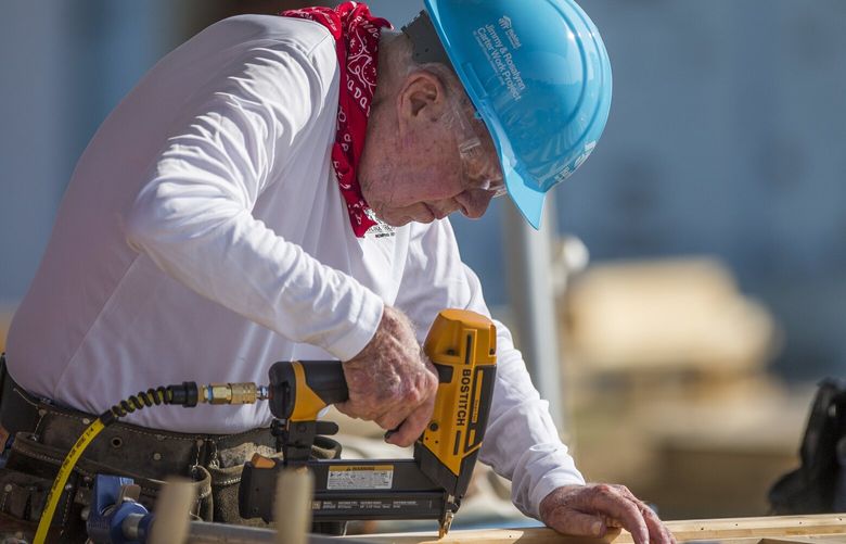 FILE- In this Aug. 27, 2018 file photo, former President Jimmy Carter works with other volunteers on site during the first day of the weeklong Jimmy & Rosalynn Carter Work Project, their 35th work project with Habitat for Humanity, in Mishawaka, Ind. Carter turns 95 on Tuesday, Oct. 1, 2019. (Robert Franklin/South Bend Tribune via AP, File) car103 car103
