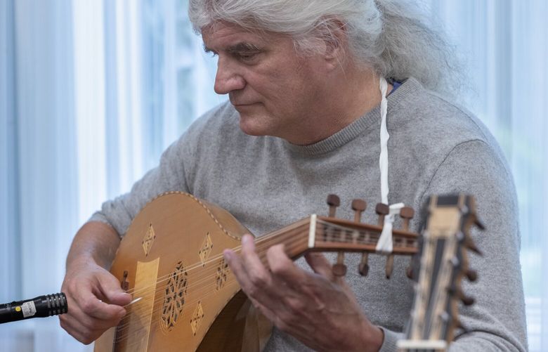 Gus Denhard, the artistic director of Early Music Seattle,  plays a medieval lute during an informal lute concert at The Gardens at Town Square, a retirement community in Bellevue, Thursday, September 26, 2024.  

(The story is about Seattle’s early music scene and the musicians here who play pre-modern instruments). 228125