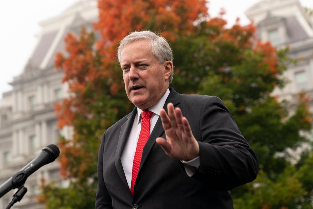 arafed image of a man in a suit and tie speaking into a microphone