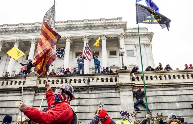 FILE – Supporters of then President Donald Trump storm the Capitol in Washington on Jan. 6, 2021. Michael Oliveras was sentenced to five years in prison and another man, James Weeks, received a little over two years on Friday, October. 4, 2024, for their various crimes, including attacking police officers, connected to breaching the U.S. Capitol during Jan. 6 riot. (Jason Andrew/The New York Times) XNYT0827 XNYT0827