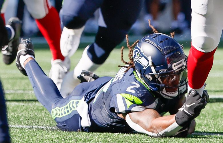 New York Giants quarterback Daniel Jones avoids the tackle of Seattle Seahawks safety Rayshawn Jenkins as he breaks out of the pocket during the second quarter Sunday, Oct. 6, 2024 in Seattle. 228170