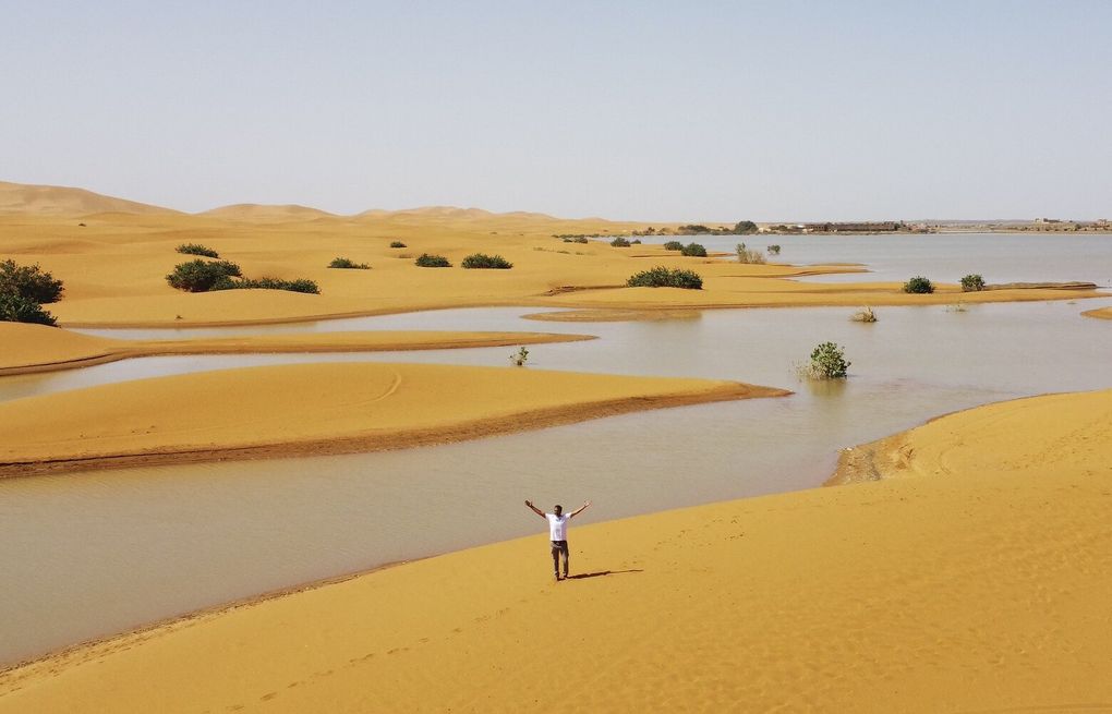 Water gushes through sand dunes after a rare rainfall in the Sahara desert  | The Seattle Times
