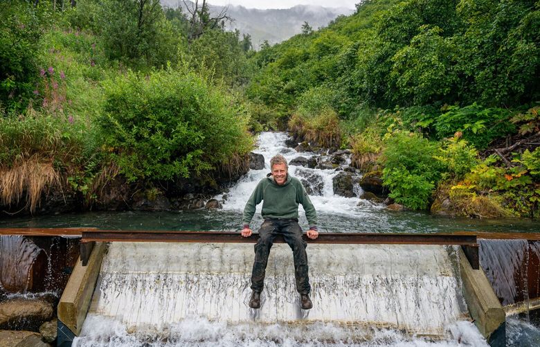 Hydrologist David Brailey developed this small hydro project that generates power from water flowing down a Chugach Mountain creek.  Here, he sits above a spillway that collect the water for the 300 kilowatt project. 

Hydrologist David Brailey sits above a spillway that collects water from an unnamed creek, locally known as Juniper Creek, at the Juniper Creek hydro project on Saturday, Aug. 14, 2021 in Eagle River. The 300kW run-of-river hydro project near Ram Valley came online at the end of July. (Loren Holmes / ADN)