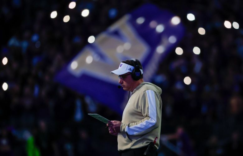Washington Huskies head coach Jedd Fisch looks at plays during a time out in the fourth quarter Saturday, Oct. 5, 2024 in Seattle. 228174