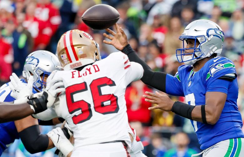 Seattle Seahawks quarterback Geno Smith gets rid of the ball before San Francisco 49ers defensive end Leonard Floyd closes in during the second quarter Thursday, Oct. 10, 2024 in Seattle. 228206