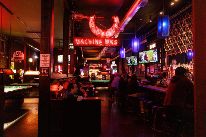 Patrons congregate at Seattle Tavern &#038; Pool Room in Georgetown on a recent evening. (Erika Schultz / The Seattle Times)