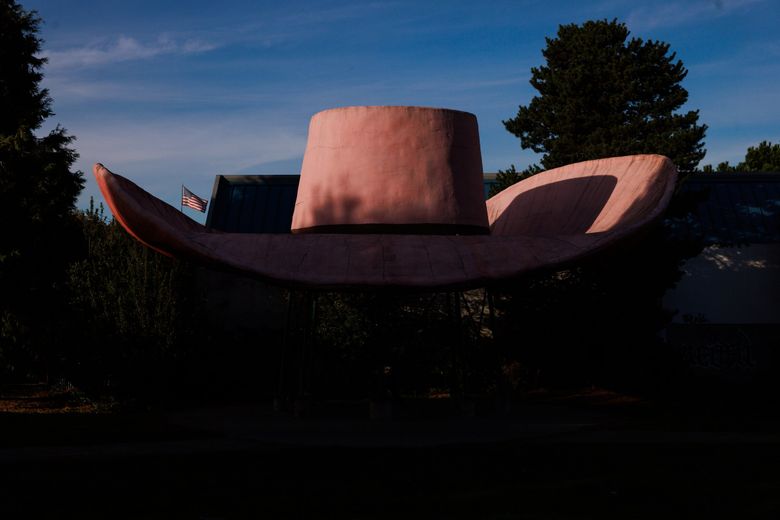 Afternoon light illuminates the top of the 44-foot wide hat of Hat n&#8217; Boots in Oxbow Park in Georgetown, created by Seattle artist Lewis Nasmyth. (Erika Schultz / The Seattle Times)