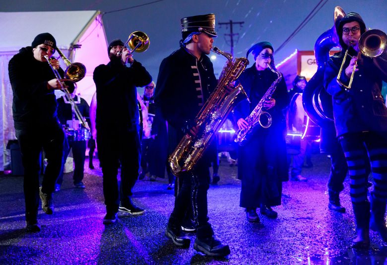 Allan Levy, center, performs with the Chaotic Noise Marching Corps during Equinox Studios&#8217; Very Open House last December. (Erika Schultz / The Seattle Times)