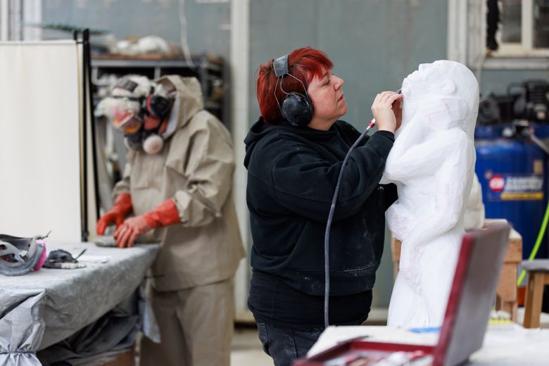 Cyra Jane works at Stoneyard Sculpture Studios at Equinox Studios in Georgetown. This sculpture started as an 800-pound block of Italian marble a friend found in a garage in Portland. (Erika Schultz / The Seattle Times)