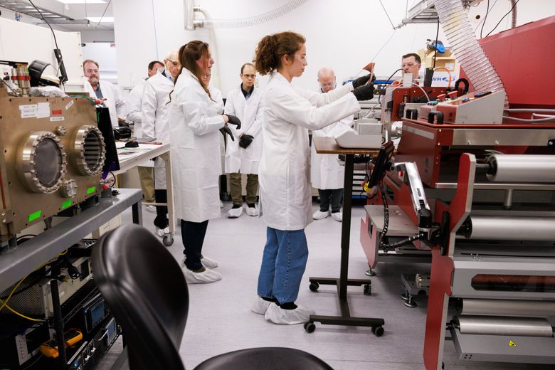 During a tour of Washington Clean Energy Testbeds, staff scientist Sarah Little works at a station coating an electrode that goes into a pouch cell battery. The Clean Energy Institute is expanding the Washington Clean Energy Testbeds, an open-access climate tech facility, to facilitate the fabrication of pouch cell batteries. (Erika Schultz / The Seattle Times)