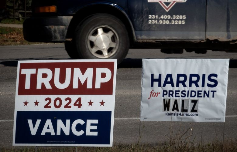 Signs showing support for both Democratic presidential candidate Vice President Kamala Harris and Republican presidential candidate former President Donald Trump sit along a rural highway on Sept. 26, 2024, near Traverse City, Michigan. Michigan is one of the few swing states expected to have the biggest impact on selecting the next U.S. president. (Scott Olson/Getty Images/TNS) 124423709W 124423709W