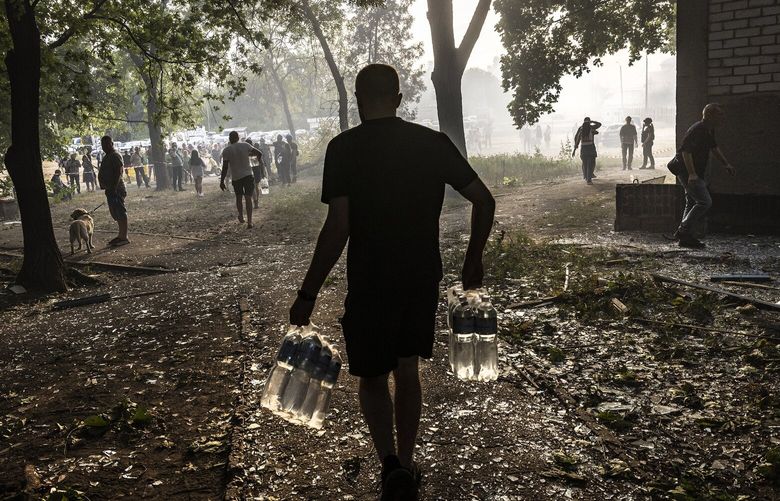FILE — Ukrainian residents step over shattered glass as they leave after a Russian attack in Kharkiv, Ukraine on Aug. 30, 2024. Biden announced $425 million in aid to Ukraine which includes munitions, armored vehicles and other weapons. (David Guttenfelder/The New York Times) XNYT0708 XNYT0708
