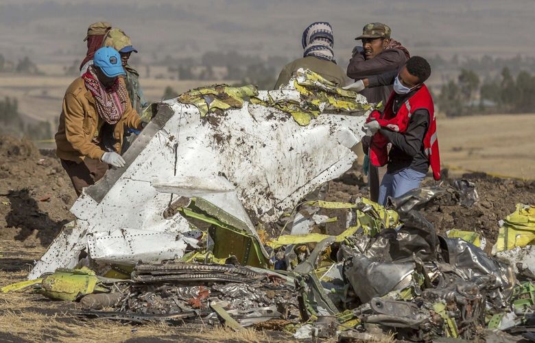 Workers at the scene of the Ethiopian Airlines crash south of Addis Ababa, Ethiopia’s capital, in 2019. The Boeing 737 MAX crash killed 157 people. (AP Photo / Mulugeta Ayene)