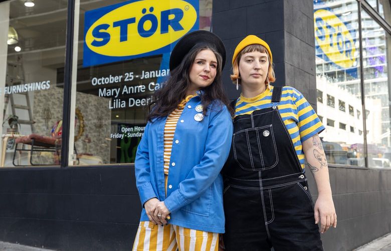 Mary Anne Carter, left, and Lilia Deering, creators of STÖR, a downtown Seattle tongue-in-cheek art exhibit based on IKEA, pose for a photo on Thursday, Oct. 24, 2024.