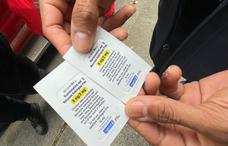 Seattle Fire Department firefighter and EMT William Whatley holds package of buprenorphine, a medication that blocks opioid withdrawal symptoms and prevents an opioid overdose for about one day.