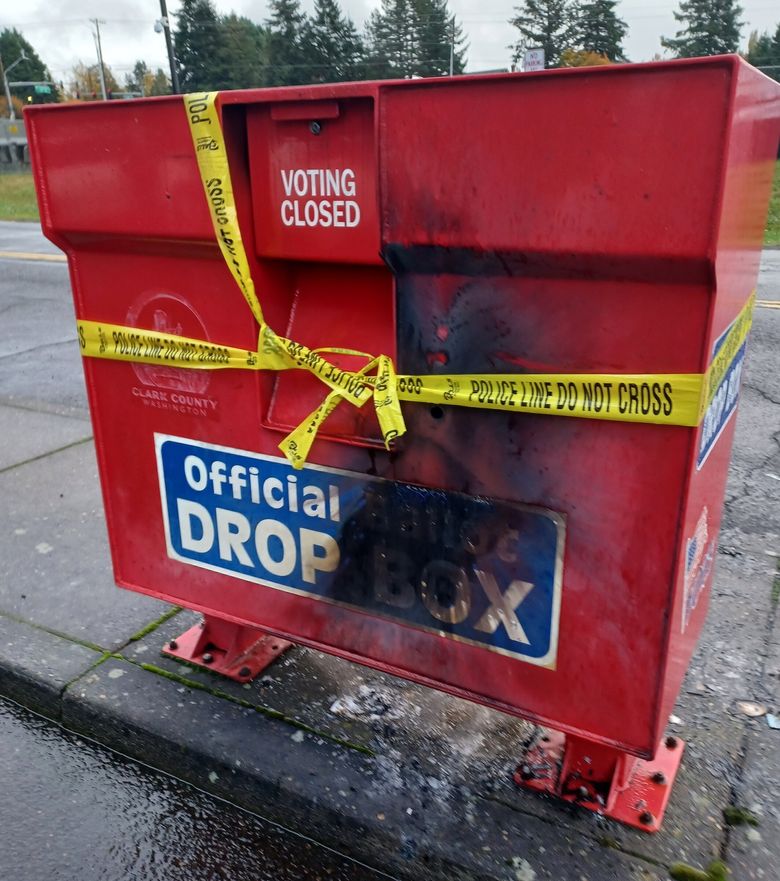 Police tape wraps a fire-damaged ballot drop box at Fisher’s Landing Transit Center in Vancouver, Washington, on Monday, after some sort of explosive started a fire that damaged hundreds of ballots. (Monika Spykerman / The Columbian)