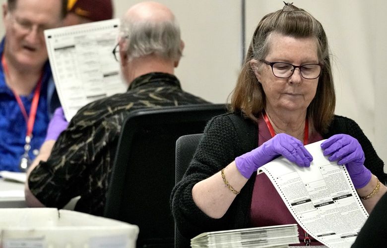 Elections officials process mail-in ballots prior to first day of tabulation in Maricopa County, Wednesday, Oct. 23, 2024, at the Maricopa County Recorder’s Office in Phoenix. (AP Photo/Matt York) AZMY107 AZMY107