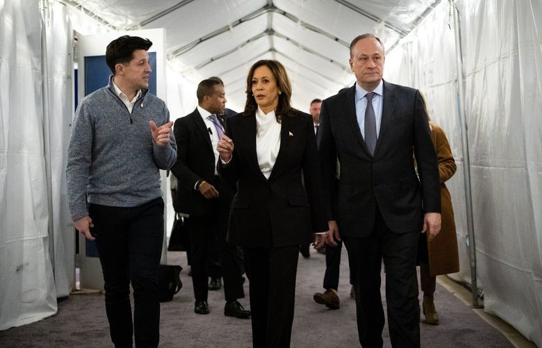 Vice President Kamala Harris, the Democratic presidential nominee, arrives backstage with second gentleman Doug Emhoff, before her campaign rally in Washington on Tuesday, Oct. 29, 2024. Harris told reporters on Wednesday that she disagreed “with any criticism of people based on who they vote for.” (Erin Schaff/The New York Times) XNYT0994 XNYT0994