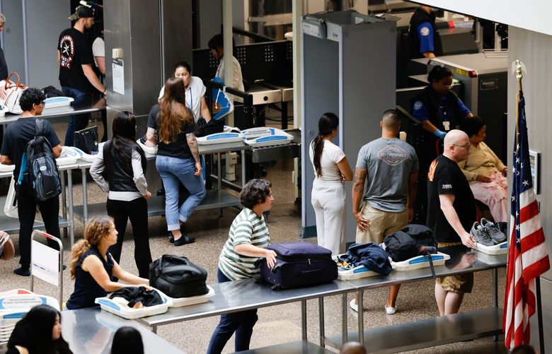 Passengers go through a TSA security checkpoint at Seattle-Tacoma International Airport  in SeaTac on Labor Day, Monday, September 2, 2024. Crowds were typical.