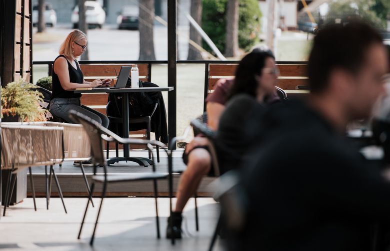 Tricia Jimo works remotely at her usual coffee shop, The Collaborative, in Tulsa, Okla., on Oct. 7, 2024. The sudden onset of remote work during the pandemic prompted some cities and states to vie for new residents with programs offering cash incentives. (Melissa Lukenbaugh/The New York Times)
