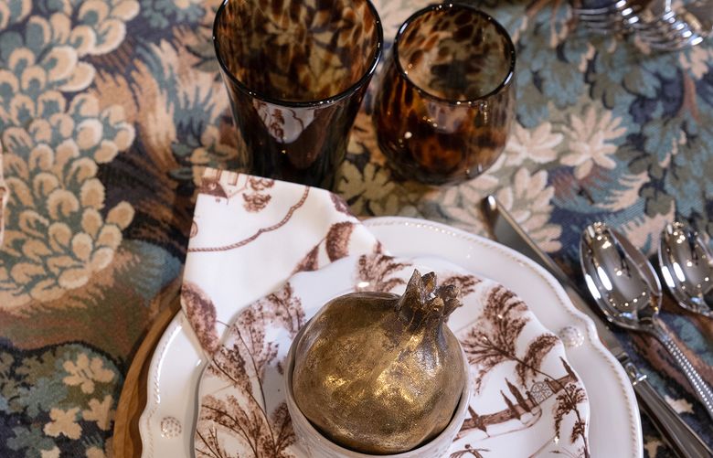 When shopping for table linens, opt for rich, textured fabrics like patterned tablecloths in warm, autumnal hues and woven materials. (Georgia Johnson, Nell Hill’s/TNS)