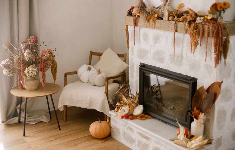 A trip to the grocery or craft store can add a ton of fall color to your space. Add candles, gourds and garlands to your mantle or table for a festive look. (Getty Images)
