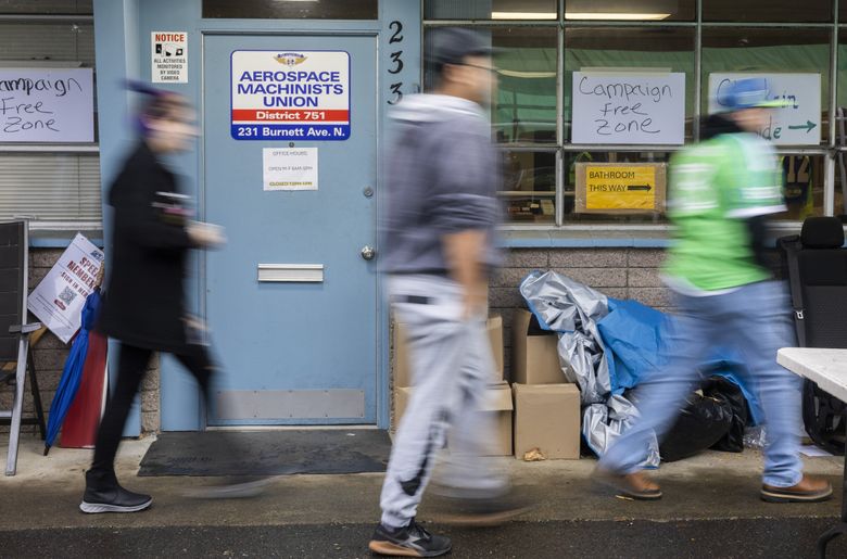 Striking Boeing Machinists, many from the Boeing Renton plant, head inside the Machinists union building in Renton to vote Monday on the most recent contract offer. (Ellen M. Banner / The Seattle Times)