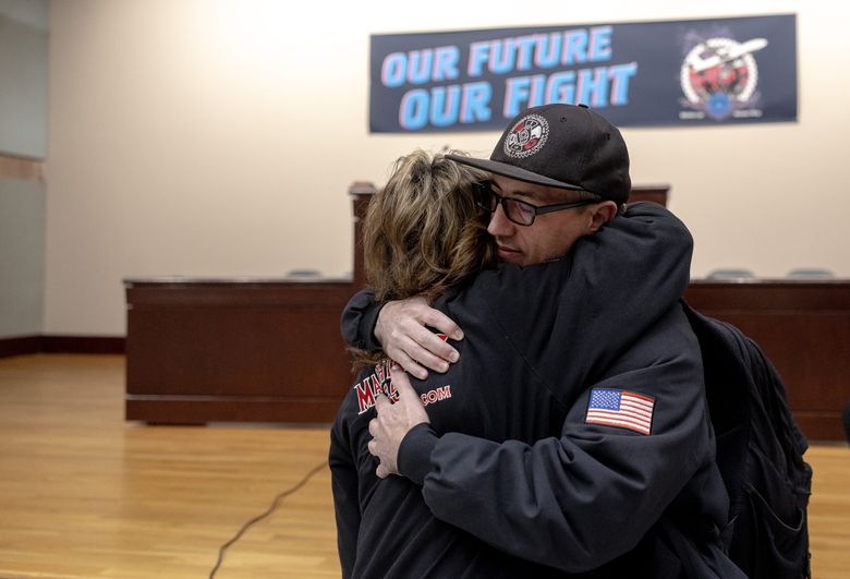 Boeing Machinists union steward and fuel cell mechanic  Jon Voss hugs union business representative Carolyn Romeo after union President Jon Holden announced that union members voted to approve Boeing’s contract offer on Monday at the Machinists headquarters in Seattle. (Nick Wagner / The Seattle Times)