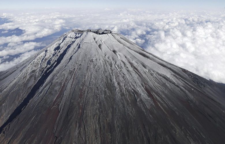 Mt. Fuji in Japan is covered with snow Wednesday, Nov. 6, 2024. (Kyodo News via AP) TKMY803 TKMY803