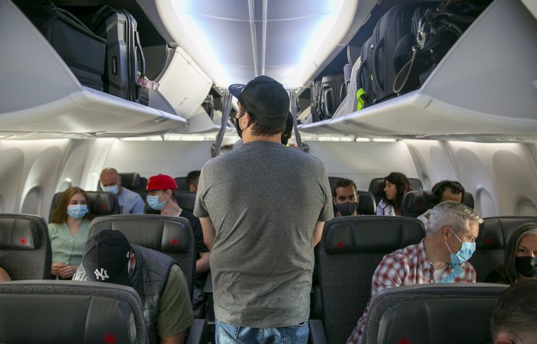 People board a Boeing 737 MAX plane operated by Air Canada at Edmonton International Airport in Alberta, Canada, on Wednesday, July 27, 2022. (AP Photo/Ted Shaffrey)