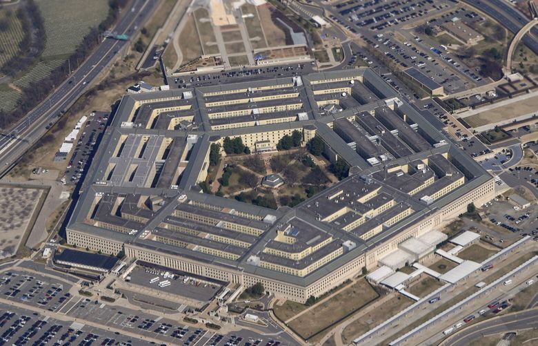 FILE – The Pentagon is seen from Air Force One as it flies over Washington, March 2, 2022. The U.S. military says explosions earlier this month on a base in eastern Syria that injured several U.S. service members were not, as it originally reported, caused by artillery or another form of indirect fire. Instead, it is now believed the April 7 attack was carried out by the â€œdeliberate placement of explosive chargesâ€ by one or more individuals at an ammunition holding area and shower facility on the base, according to a statement issued Thursday by the Operation Inherent Resolve command that oversees U.S. military operations against the Islamic State group in Syria and Iraq. (AP Photo/Patrick Semansky, File)