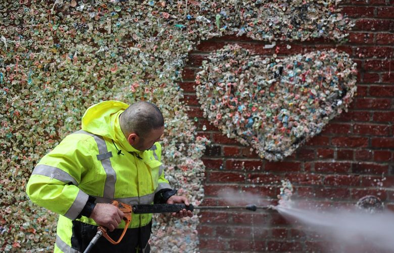 Emerson Aguilar Friday power washes the infamous Gum Wall morning in Post Alley of Pike Place Market in Seattle, Washington, on November 8, 2024. 228480