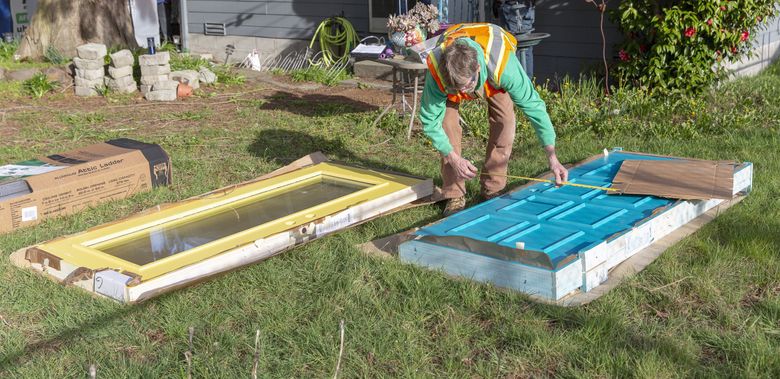 Noise insulation being applied to a window and a door used on a building in the Seattle-Tacoma International Airport flight path. (Don Wilson / Courtesy Port of Seattle)