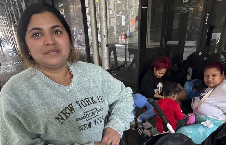 Maribel Hidalgo, 23, of Caracas, Venezuela, stands for a portrait with her son, Daniel, 2, outside a shelter for immigrants in New York, on Wednesday, Nov. 6, 2024. (AP Photo/Cedar Attanasio) RPCA601 RPCA601