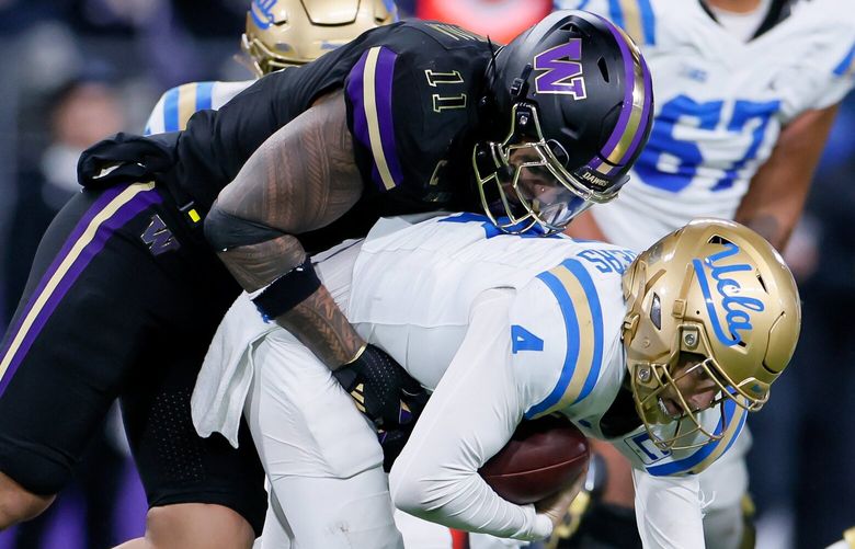 Washington Huskies linebacker Alphonzo Tuputala sacks UCLA Bruins quarterback Ethan Garbers to bring up fourth down during the fourth quarter Friday, Nov. 15, 2024 in Seattle. 228521