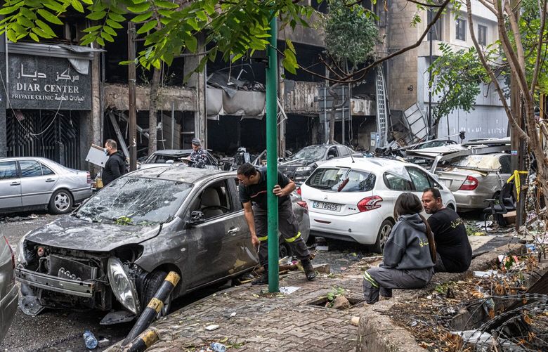 Emergency personnel take a break on Monday, Nov. 18, 2024, at the site of an Israeli strike in the Mar Elias neighborhood of Beirut. After weeks of deadly Israeli airstrikes in Lebanon and punishing combat between Israeli forces and the Hezbollah militant group, the contours of a potential cease-fire agreement appear to be taking shape according to several regional and U.S. officials briefed. (Daniel Berehulak/The New York Times) XNYT0043 XNYT0043